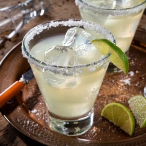 Classic Margarita cocktail with kosher salt rim and fresh lime on the side