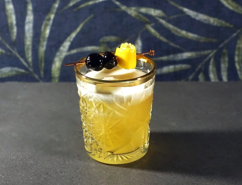 Amaretto Sour with leaf background