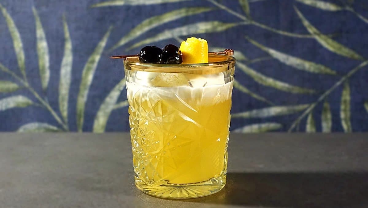Amaretto Sour Cocktail with Maraschino cherry and Lemon