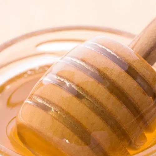 Honey syrup in jar with honey spoon