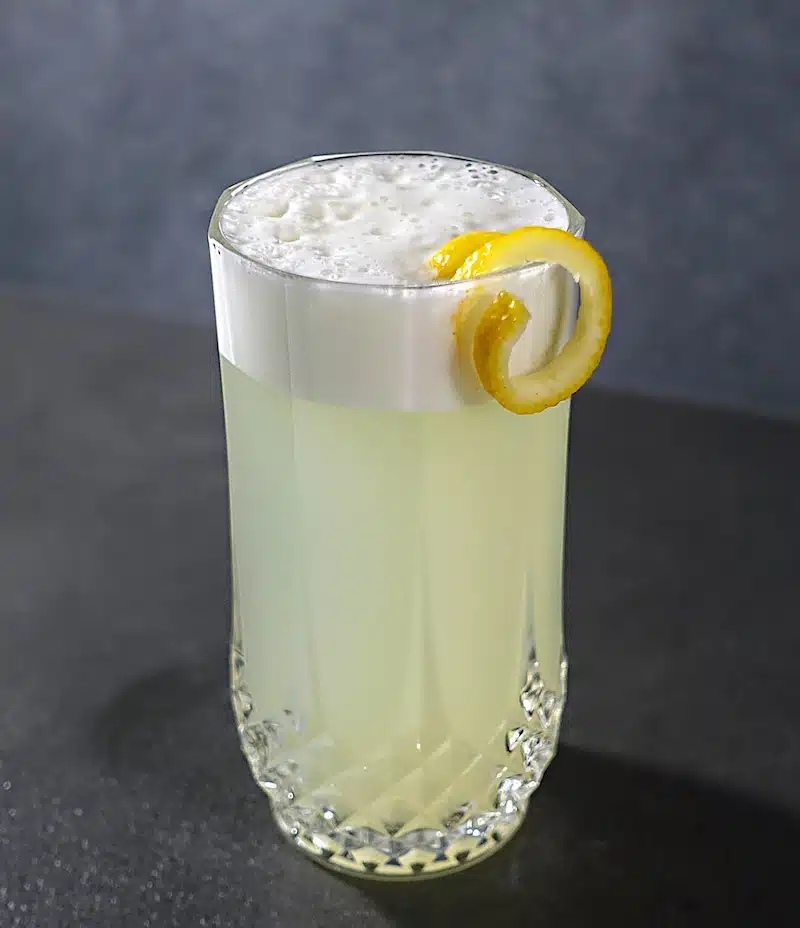 Gin Fizz with egg white foam and lemon twist