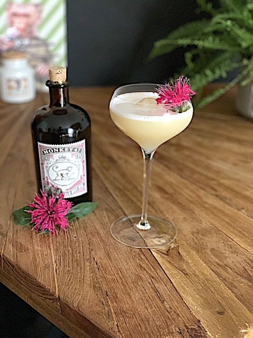 Bees Knees cocktail made with Monkey 47 Distiller's cut 2021 on table next to bottle