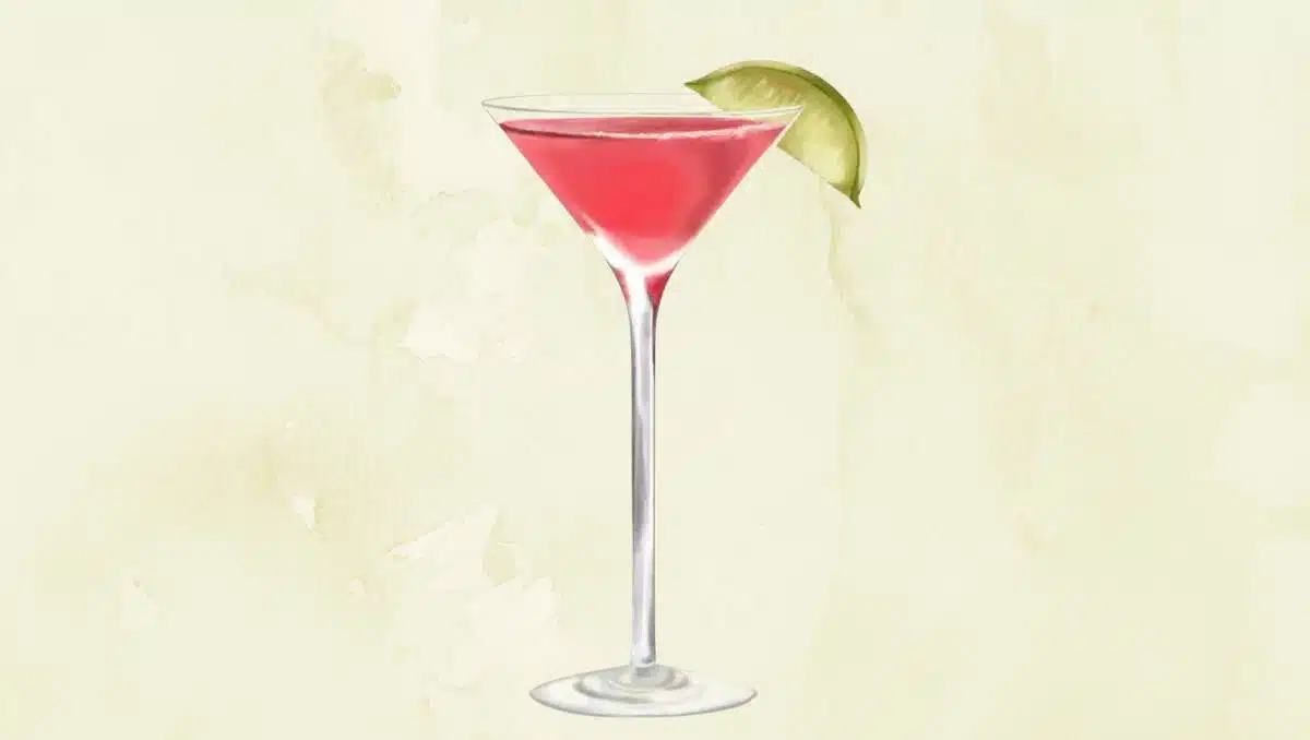 Cosmopolitan cocktail with lime wedge on light green background