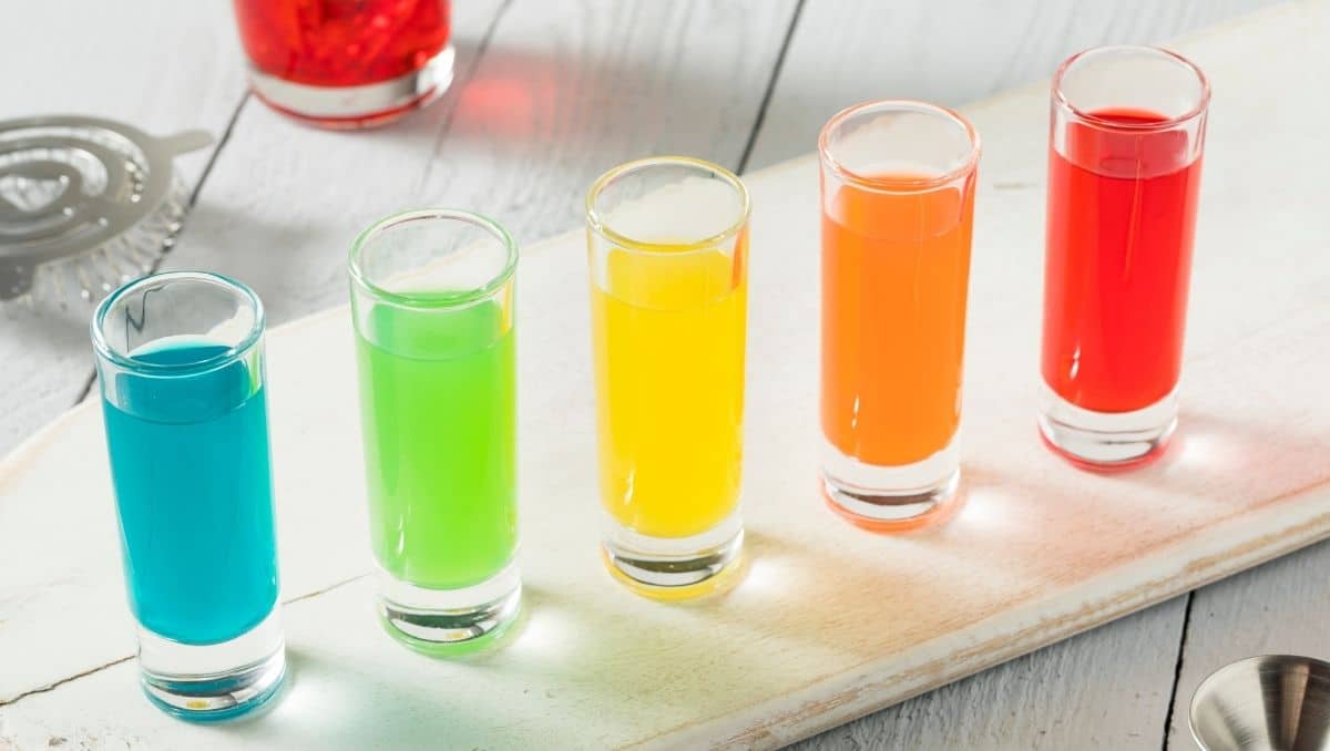 Rainbow shots in 5 glasses on white table