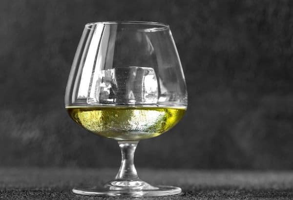 Tasting of Green Chartreuse on ice in snifter glass
