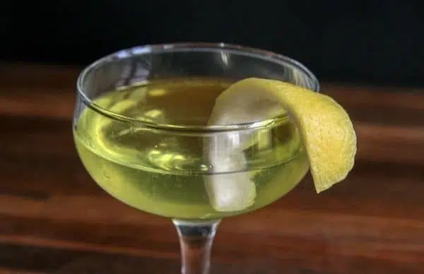Green Chartreuse in Coupe glass with lemon peel garnish