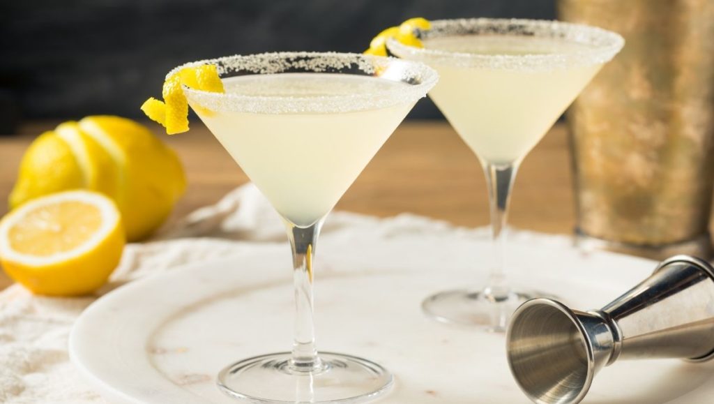 Lemon Drop Martini cocktail on plate with lemons in background
