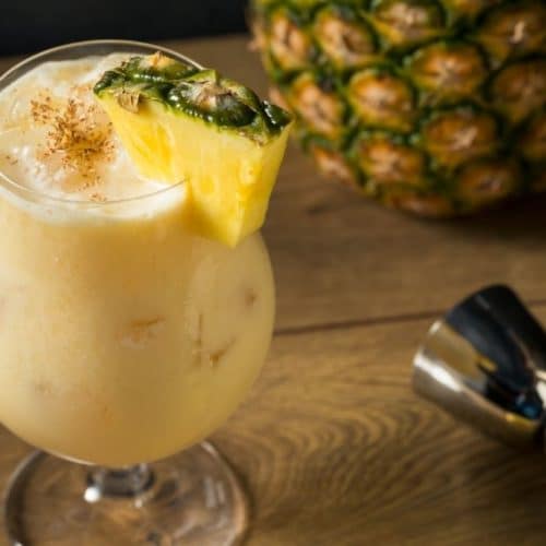 Painkiller cocktail with pineapple garnish