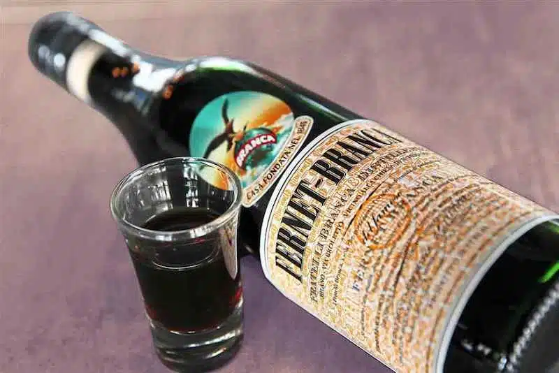 How to drink: A Shot of Fernet Branca next to a bottle of the liqueur