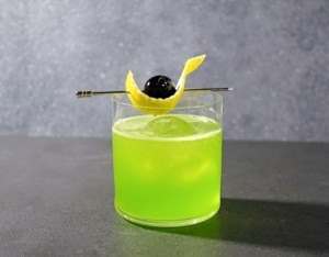 Midori Sour cocktail with cherry and lemon