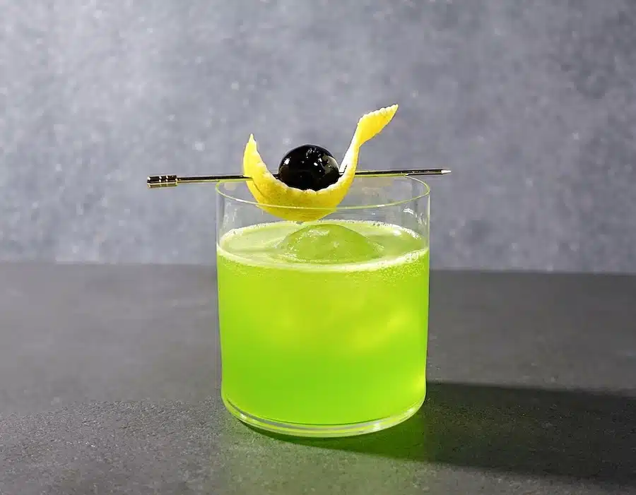 Midori Sour cocktail with cherry and lemon