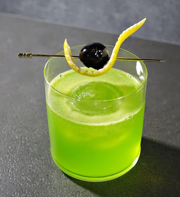 Midori Sour cocktail with cherry and lemon top view