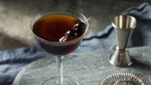 Black Manhattan cocktail with Maraschino cherry