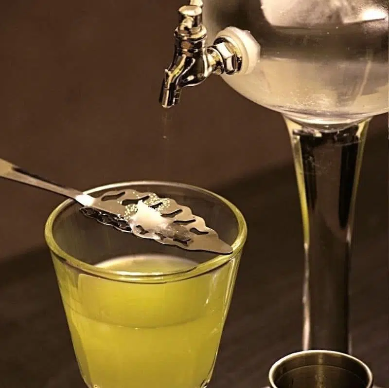 French or Swiss Absinthe preparation - Dripcold water over sugar