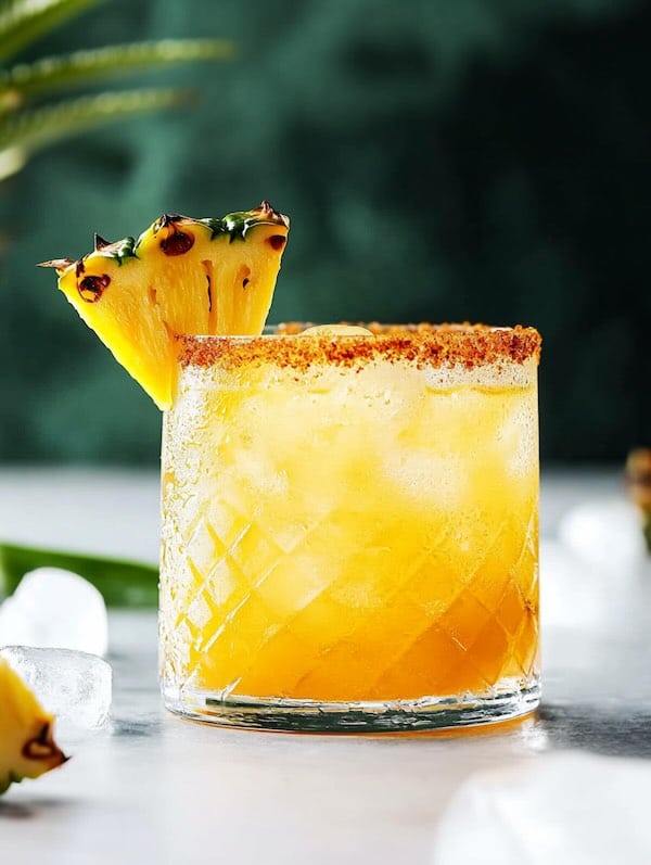 Grilled Pineapple Margarita with tajin rim and pineapple garnish