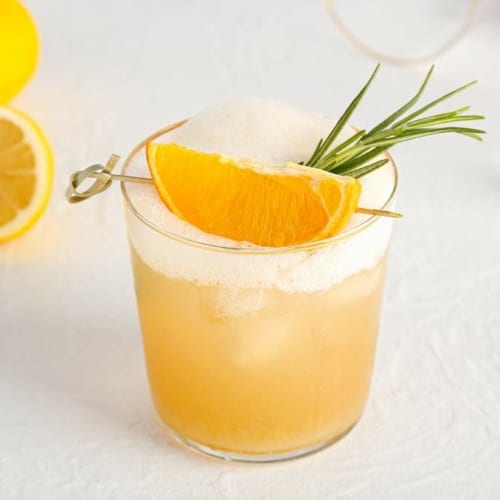 Bourbon Sour cocktail with orange wedge