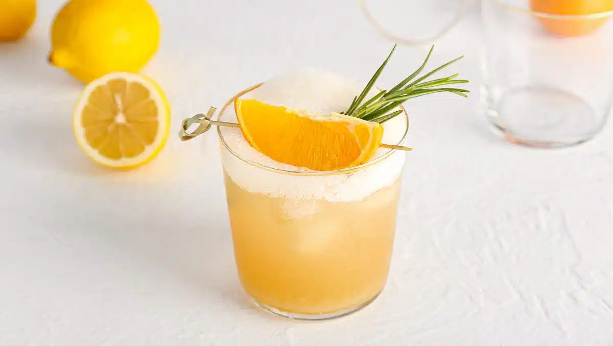 Bourbon Sour cocktail with orange wedge