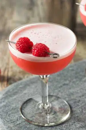 Clover Club on table with fresh raspberries