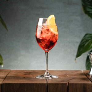 Amaro Spritz on wooden table and leaves on the side