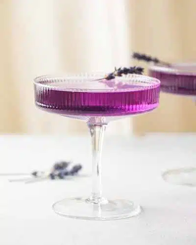 Lavender Martini on marble table garnished with lavender sprig