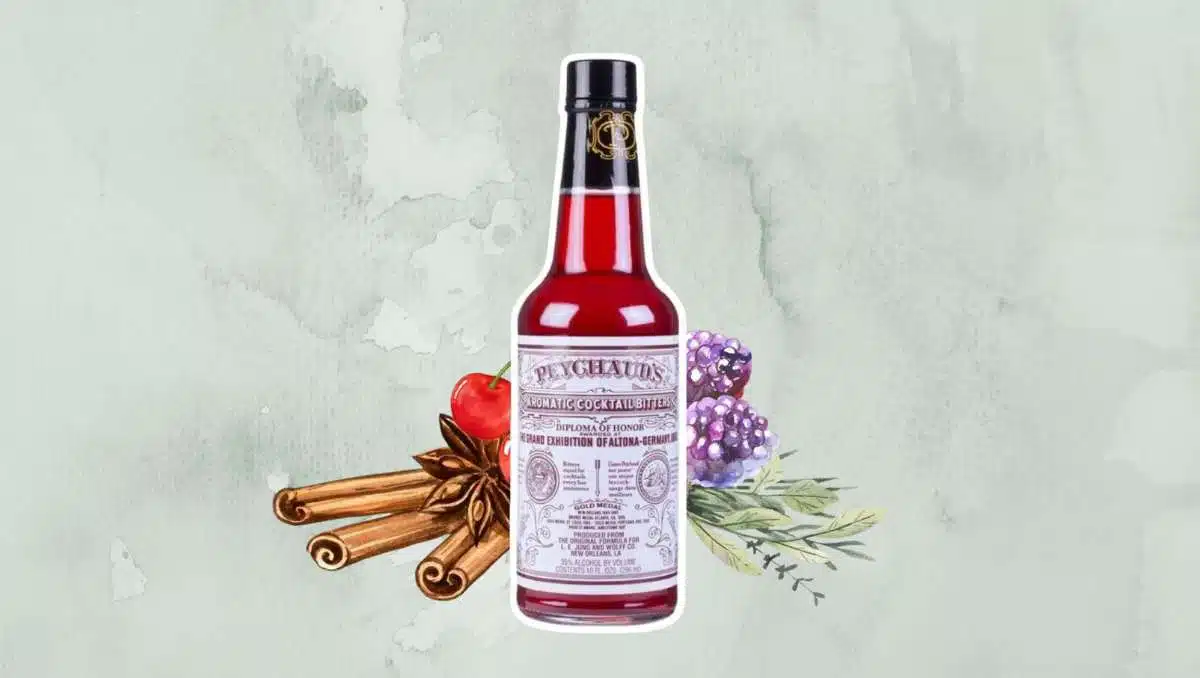 Peychaud's bitters bottle with cinnamon, berries, cherries, and herbs in the background