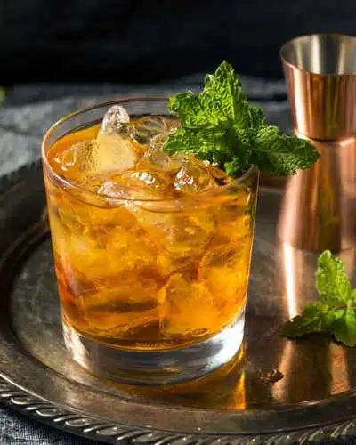 Stinger cocktail with fresh mint served on silver tray