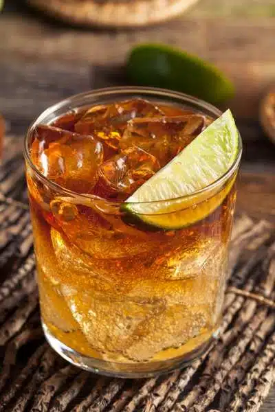 Spiced Dark 'n Stormy cocktail with lime wedge