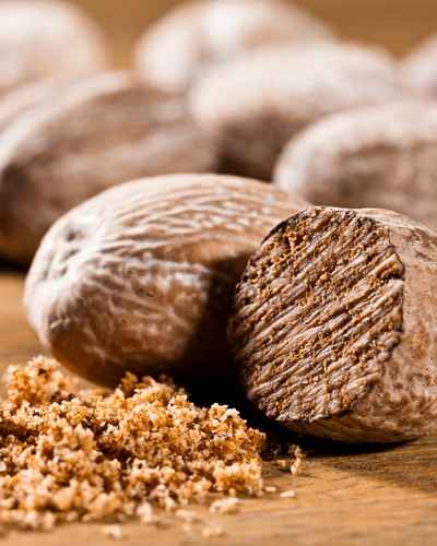 Nutmeg with freshly grated nutmeg